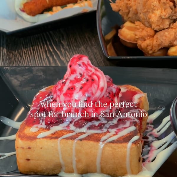 French toast with berry compote and cream, fried chicken, and bao buns on a dark table.